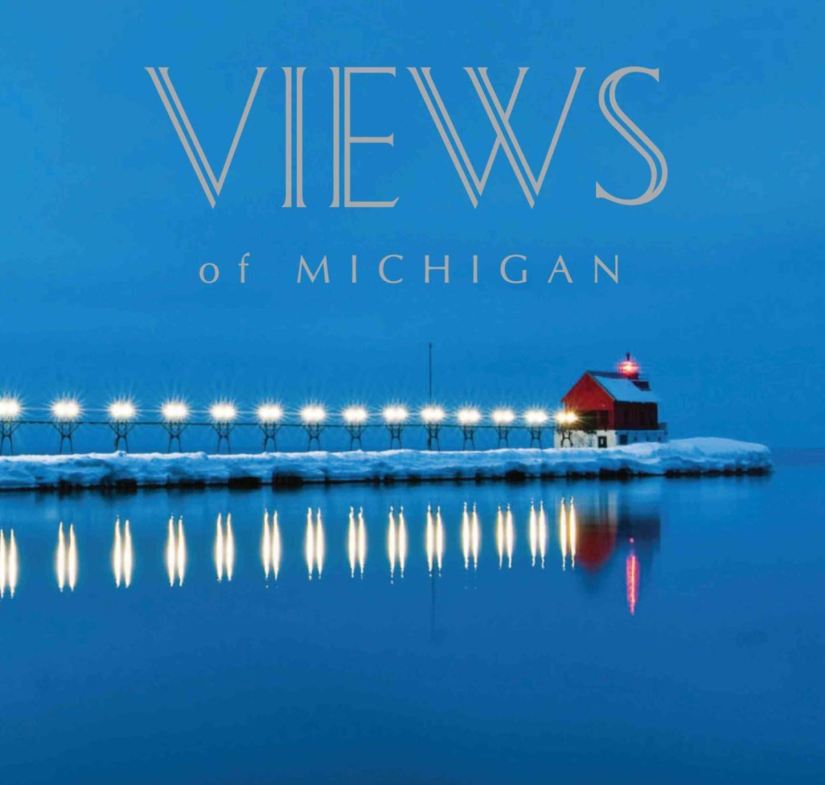 A blue book cover with a red lighthouse over water on a winter evening.